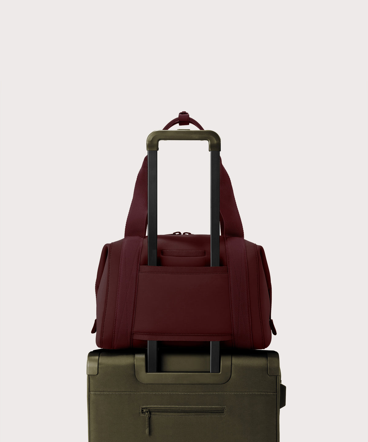 Dagne Dover Medium Landon Carryall in a deep brown with purple undertones displaying luggage sleeve.