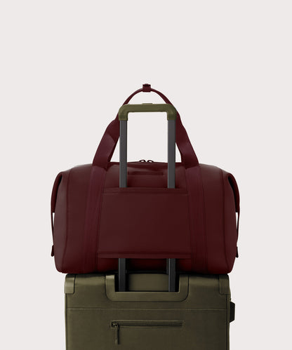 Dagne Dover Extra Large Landon Carryall in a deep brown with purple undertones displaying luggage sleeve.