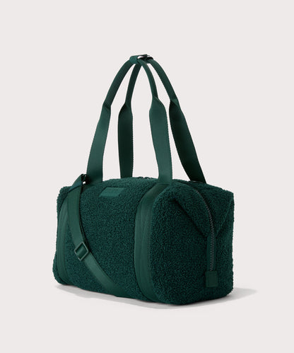 Medium landon carryall in a saturated, jewel-toned deep green with bold blue undertones.. side angle view In a Faux Shearling a soft, wool-like plush made with recycled materials