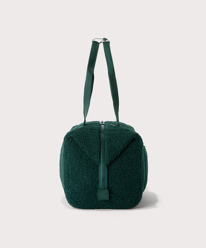 Medium landon carryall in a saturated, jewel-toned deep green with bold blue undertones., side view In a Faux Shearling a soft, wool-like plush made with recycled materials