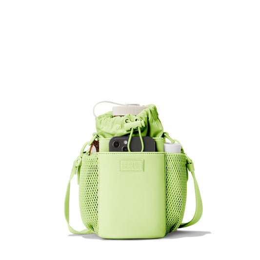 Dagne Dover Sloan Water Bottle Sling in a vibrant, creamy green containing a water bottle and accessories.