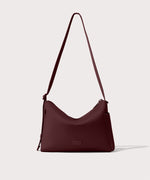 Shoulder bag in a deep brown with purple undertones reminiscent of maroon seen from the front view.