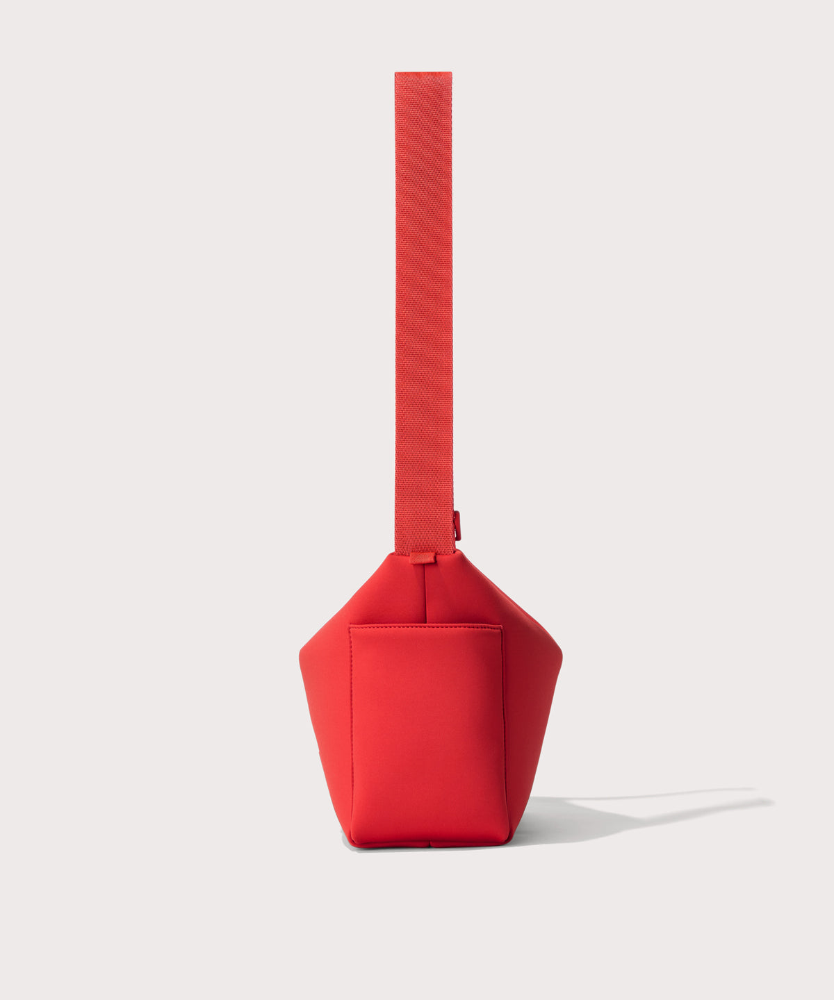 Shoulder bag in a fiery, saturated red leaning toward orange seen from the side view showing phone pocket.