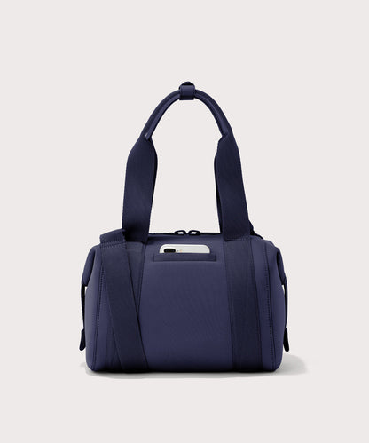 small Landon Carryall in dark blue, displaying an exterior phone pocket