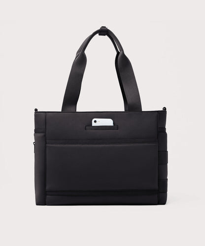 Dagne Dover large Wade Diaper Tote in black seen from the back with a phone in the exterior phone pocket.