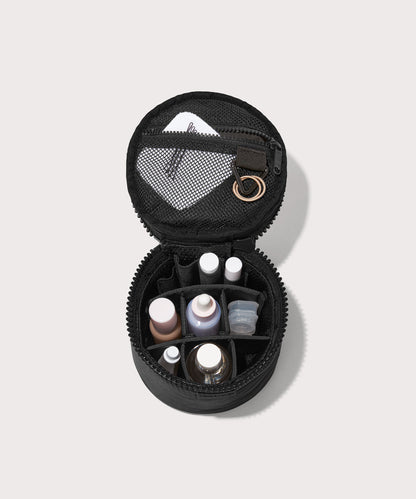 Dagne Dover small Mila Toiletry Pouch in black unzipped filled with toiletry products.