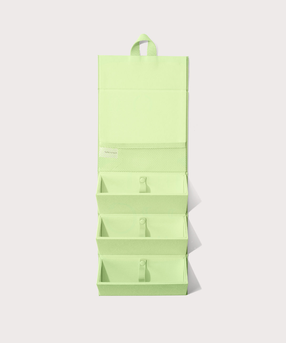 Dagne Dover Remi foldable glasses holder in matcha green hung up.