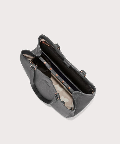 Dagne Dover medium Allyn Tote in grey with objects inside the interior pockets.