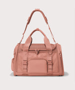 Dagne Dover Large Kyoto Pet Carrier in a warm dust pink seen from the front with crossbody strap.
