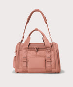 Dagne Dover small Kyoto Pet Carrier in a warm dust pink seen from the front with crossbody strap.