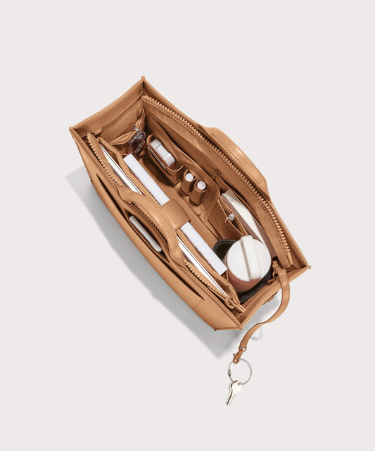 hover - Dagne Dover large vegan Daily Tote in brown from above, revealing the interior zipper, interior slip pockets, and padded laptop sleeve.